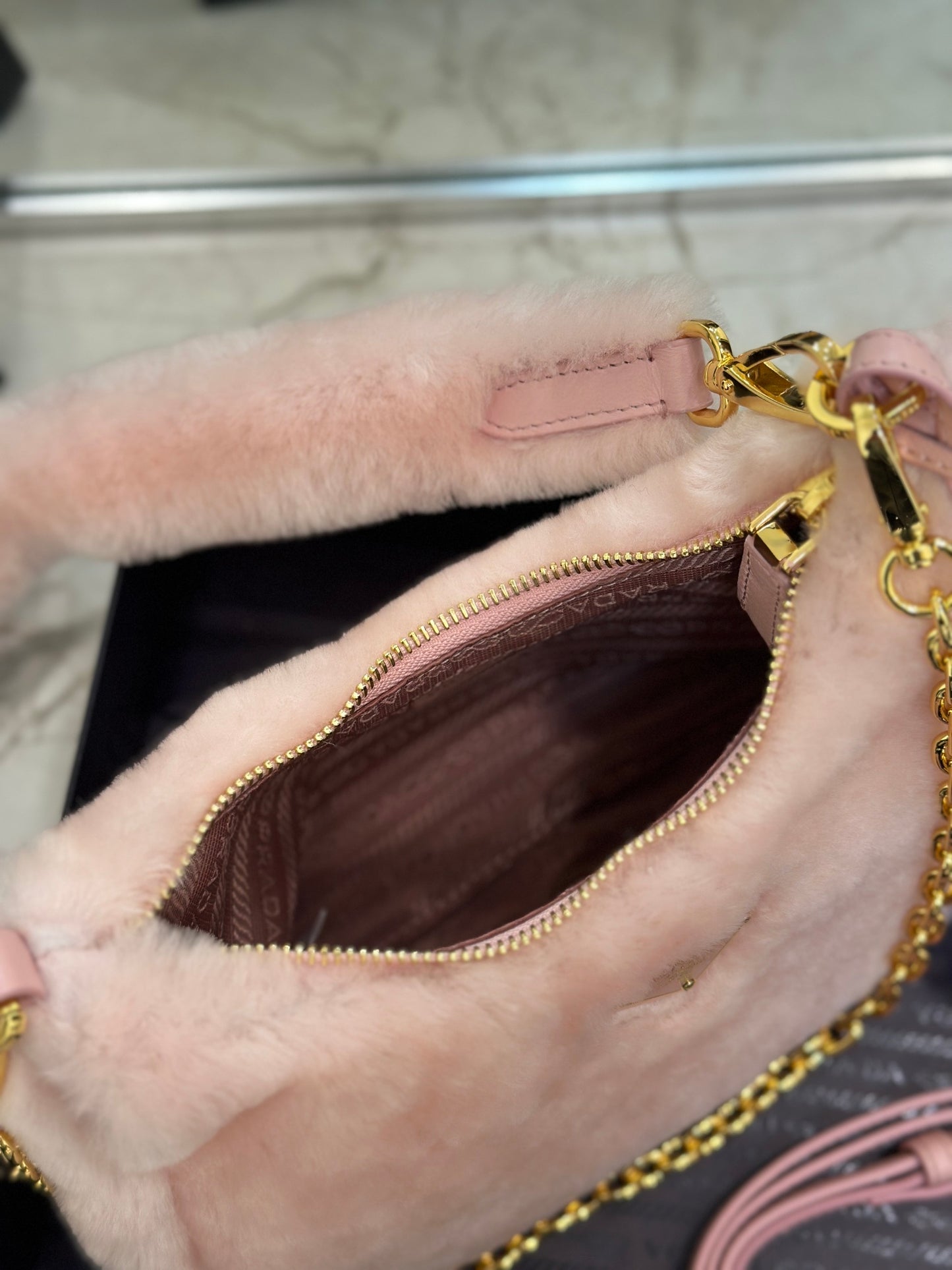 Prada Re-Edition Shearling Mini Bag – Pink with Gold-Tone Chain Strap & Enamel Logo