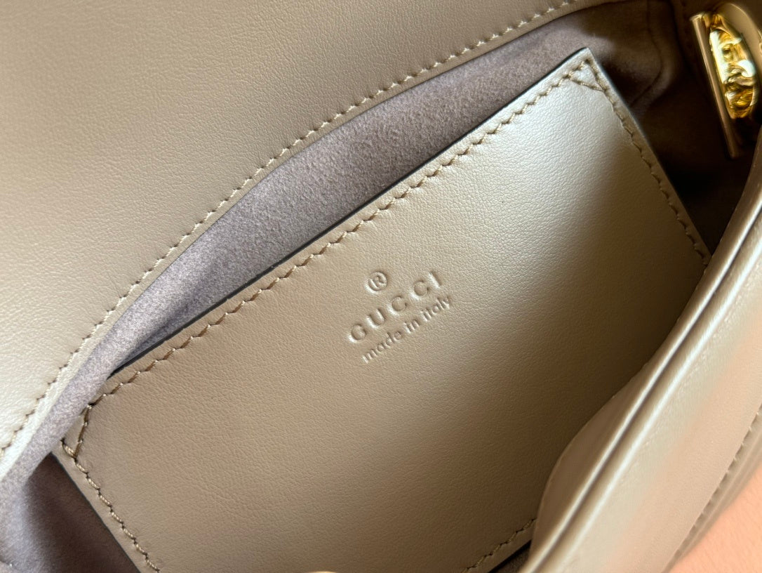 Gucci GG Marmont top handle bag in beige calfskin leather.