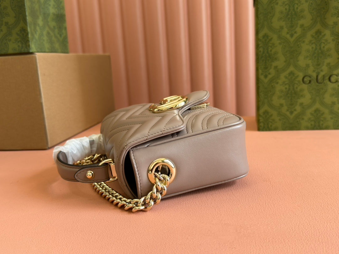 Gucci GG Marmont top handle bag in beige calfskin leather.