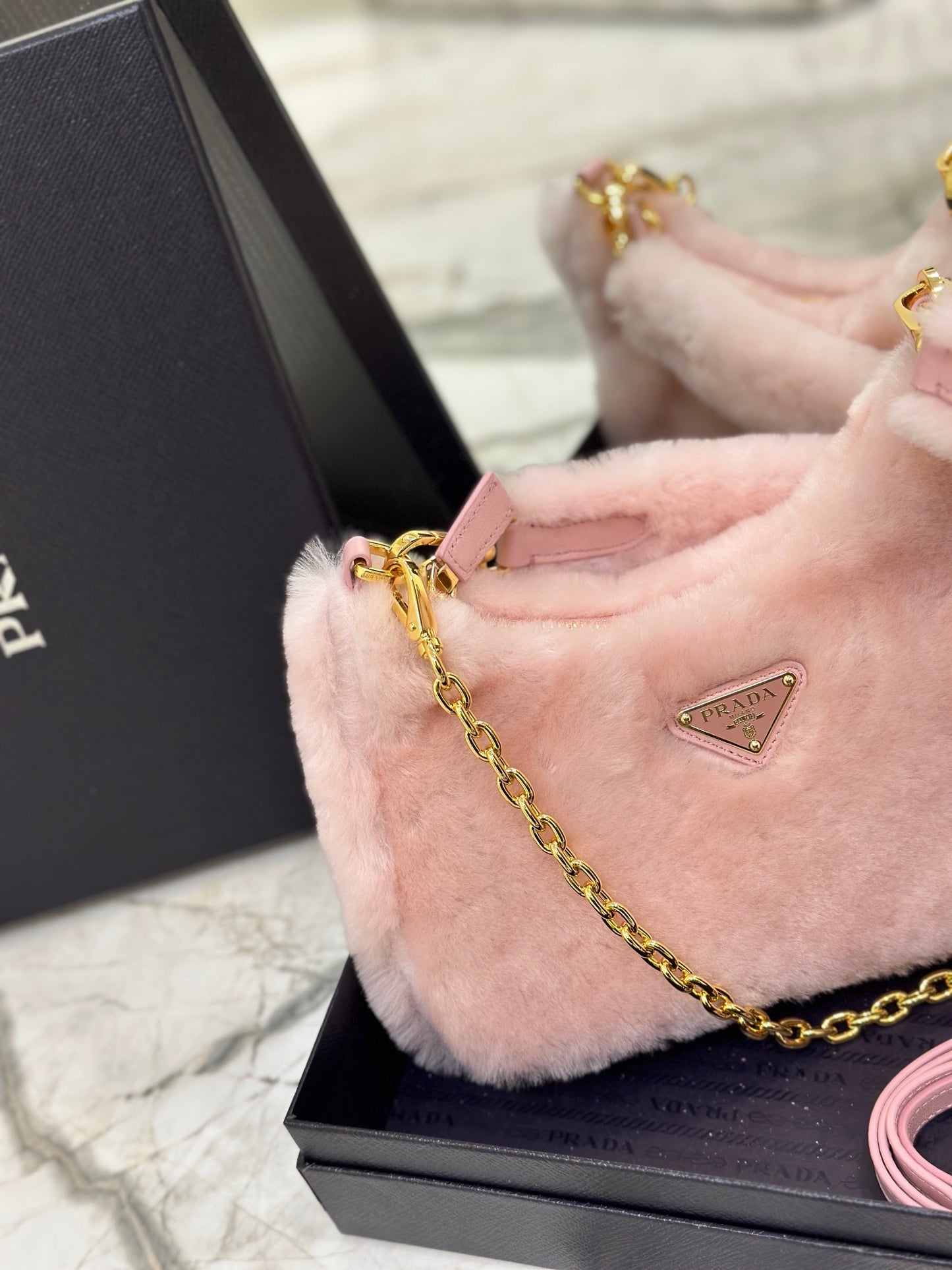 Prada Re-Edition Shearling Mini Bag – Pink with Gold-Tone Chain Strap & Enamel Logo