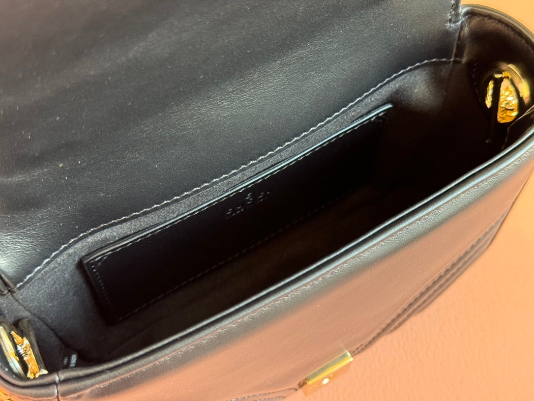 Gucci GG Marmont mini top handle bag in black quilted chevron leather.