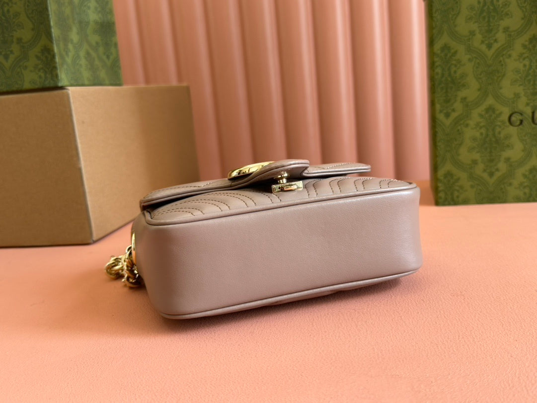 Gucci GG Marmont top handle bag in beige calfskin leather.