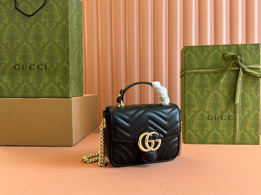 Gucci GG Marmont mini top handle bag in black quilted chevron leather.