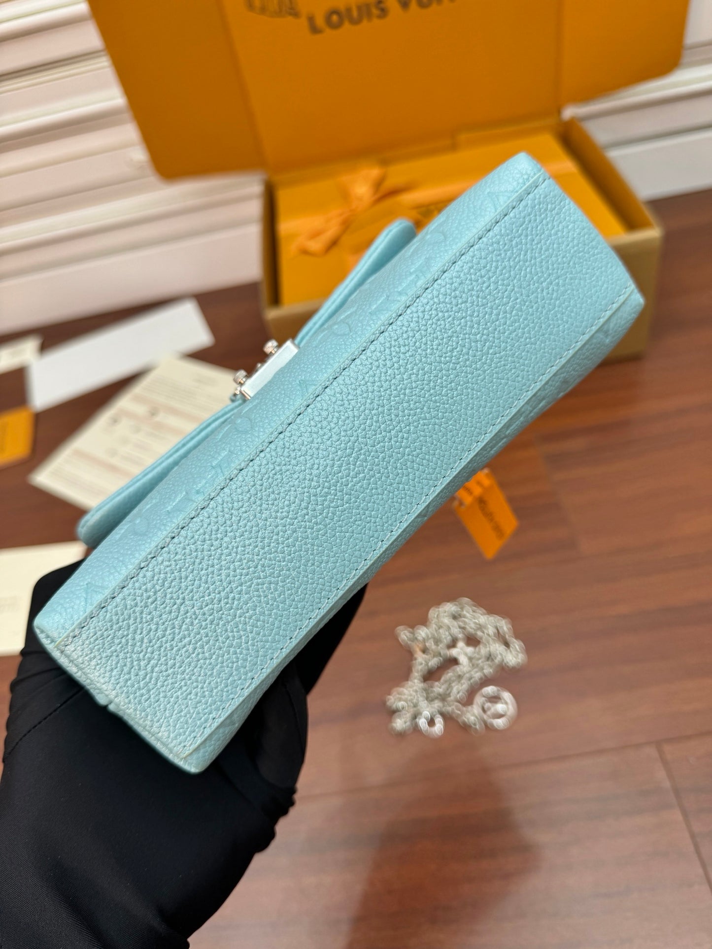 Louis Vuitton Nano Madeleine bag in the Azur Frost color in Monogram Empreinte leather.