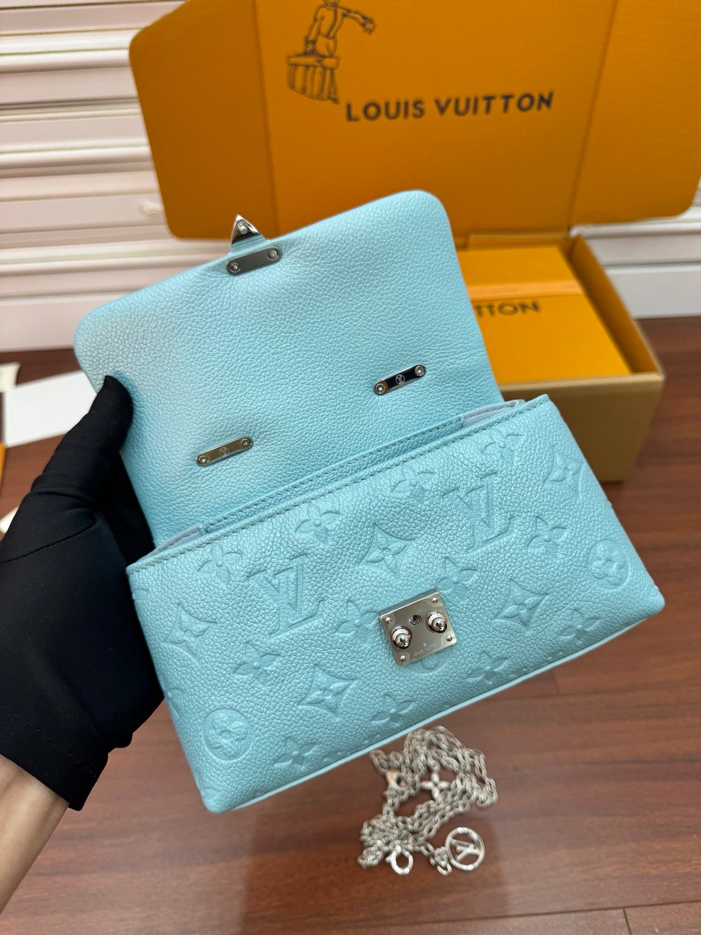 Louis Vuitton Nano Madeleine bag in the Azur Frost color in Monogram Empreinte leather.