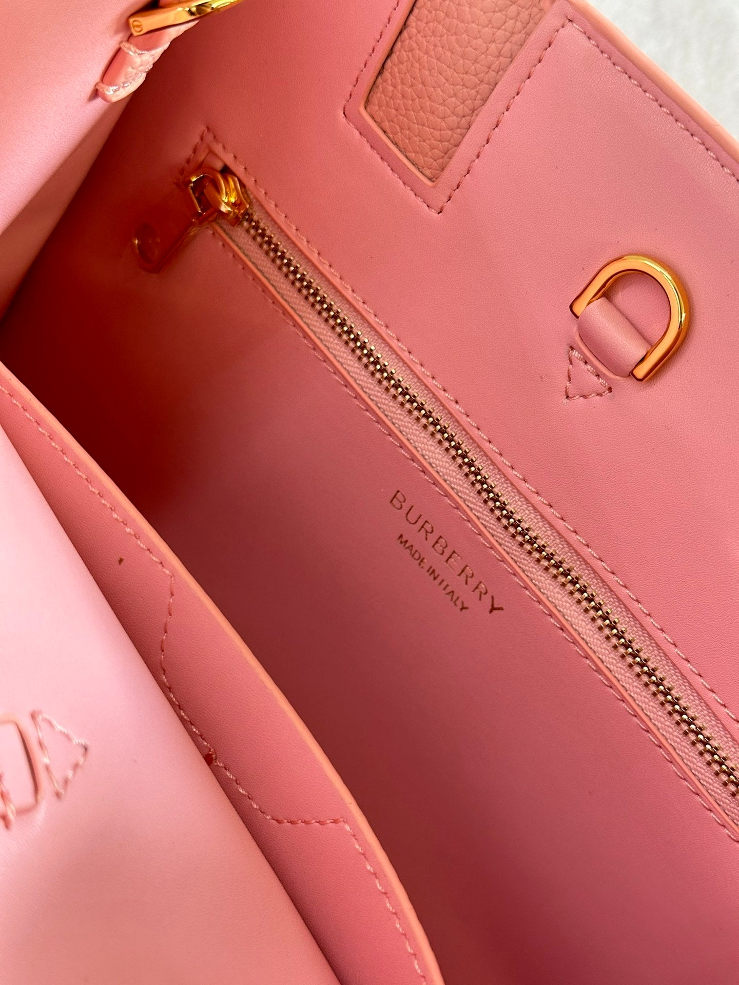 This is a Burberry Mini Frances Bag in dusky pink grainy leather, featuring the Thomas Burberry monogram in gold-tone hardware.