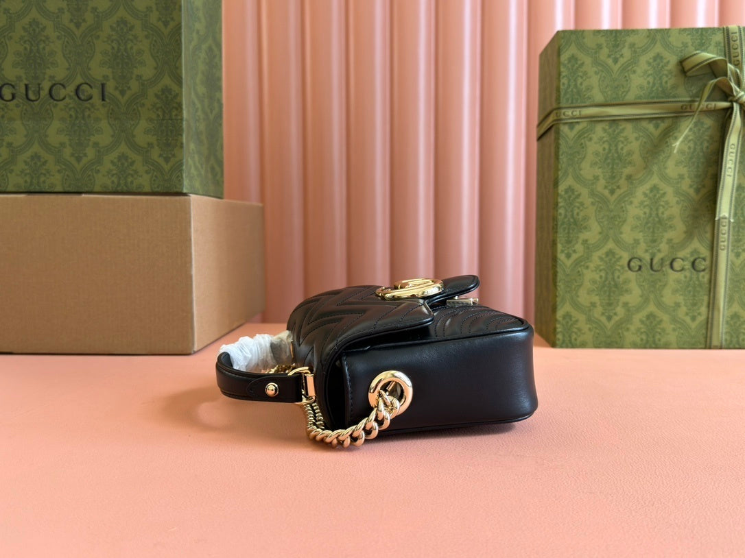 Gucci GG Marmont mini top handle bag in black quilted chevron leather.