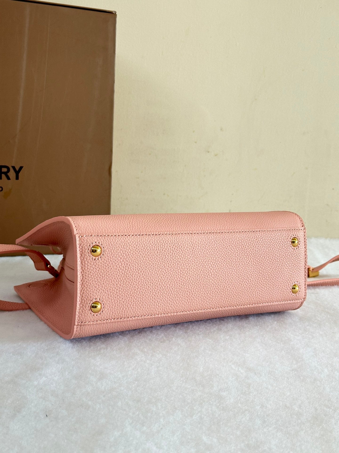 This is a Burberry Mini Frances Bag in dusky pink grainy leather, featuring the Thomas Burberry monogram in gold-tone hardware.