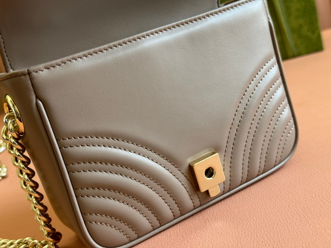 Gucci GG Marmont top handle bag in beige calfskin leather.