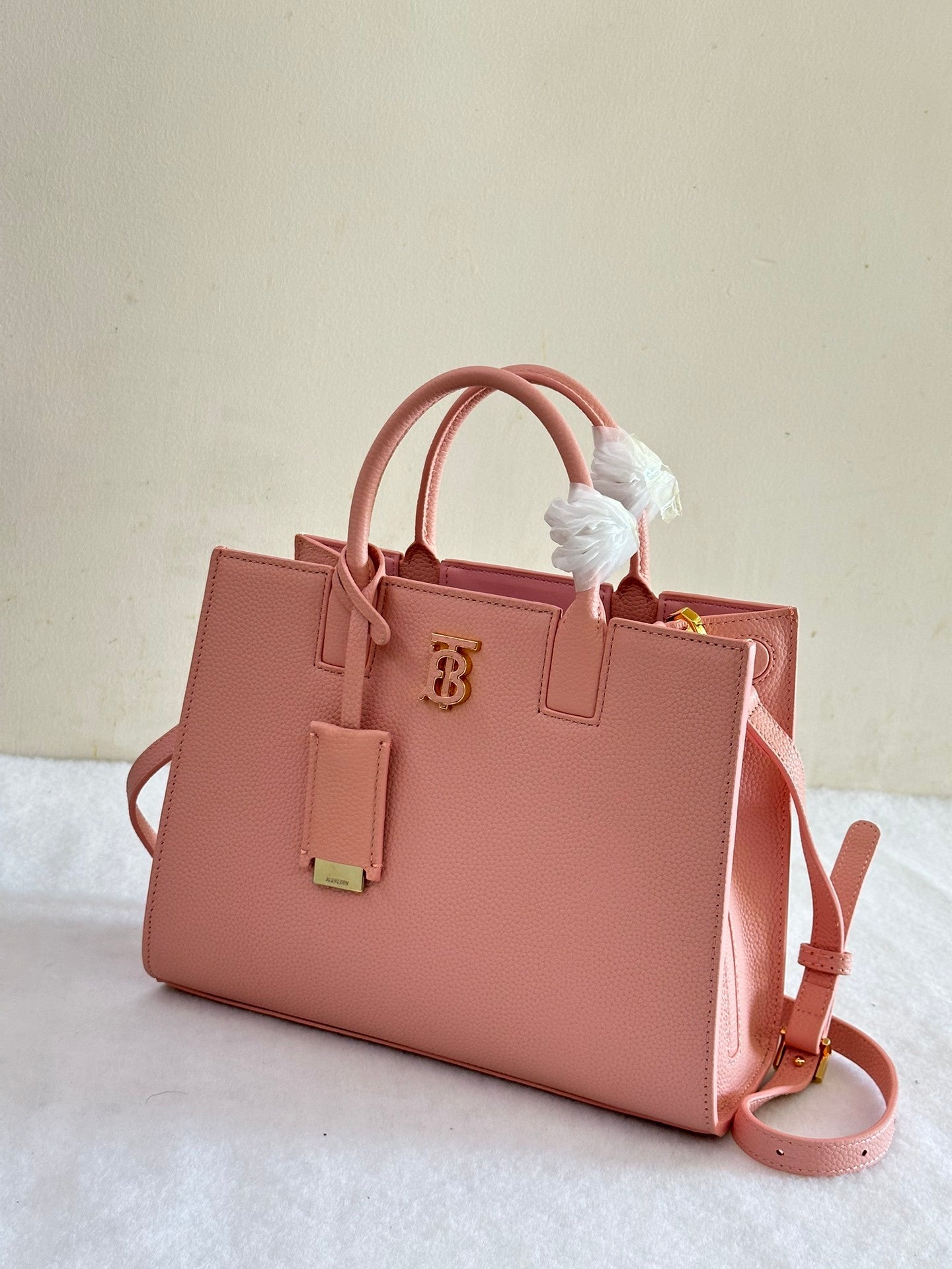 This is a Burberry Mini Frances Bag in dusky pink grainy leather, featuring the Thomas Burberry monogram in gold-tone hardware.
