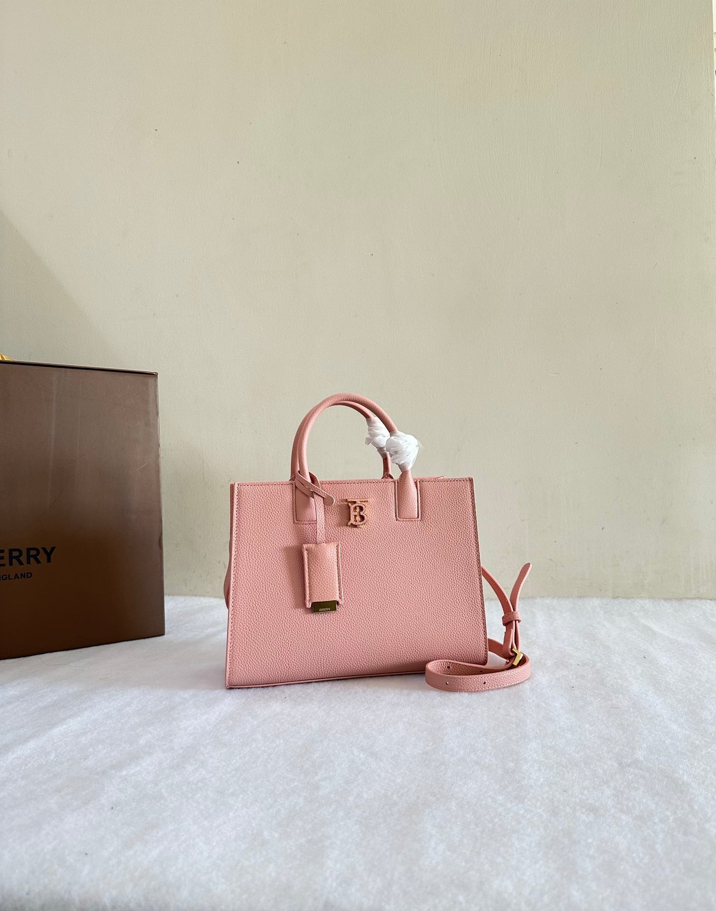 This is a Burberry Mini Frances Bag in dusky pink grainy leather, featuring the Thomas Burberry monogram in gold-tone hardware.