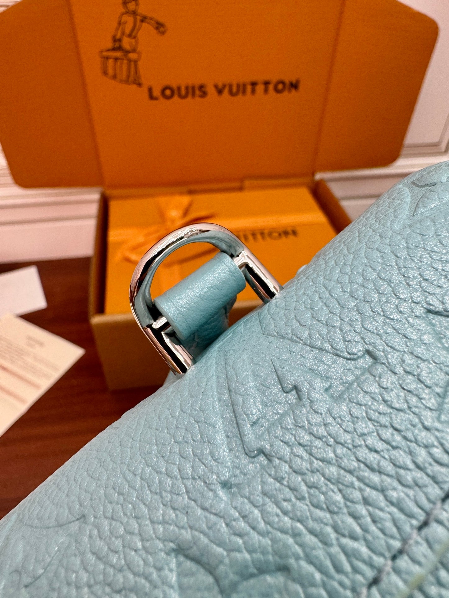 Louis Vuitton Nano Madeleine bag in the Azur Frost color in Monogram Empreinte leather.