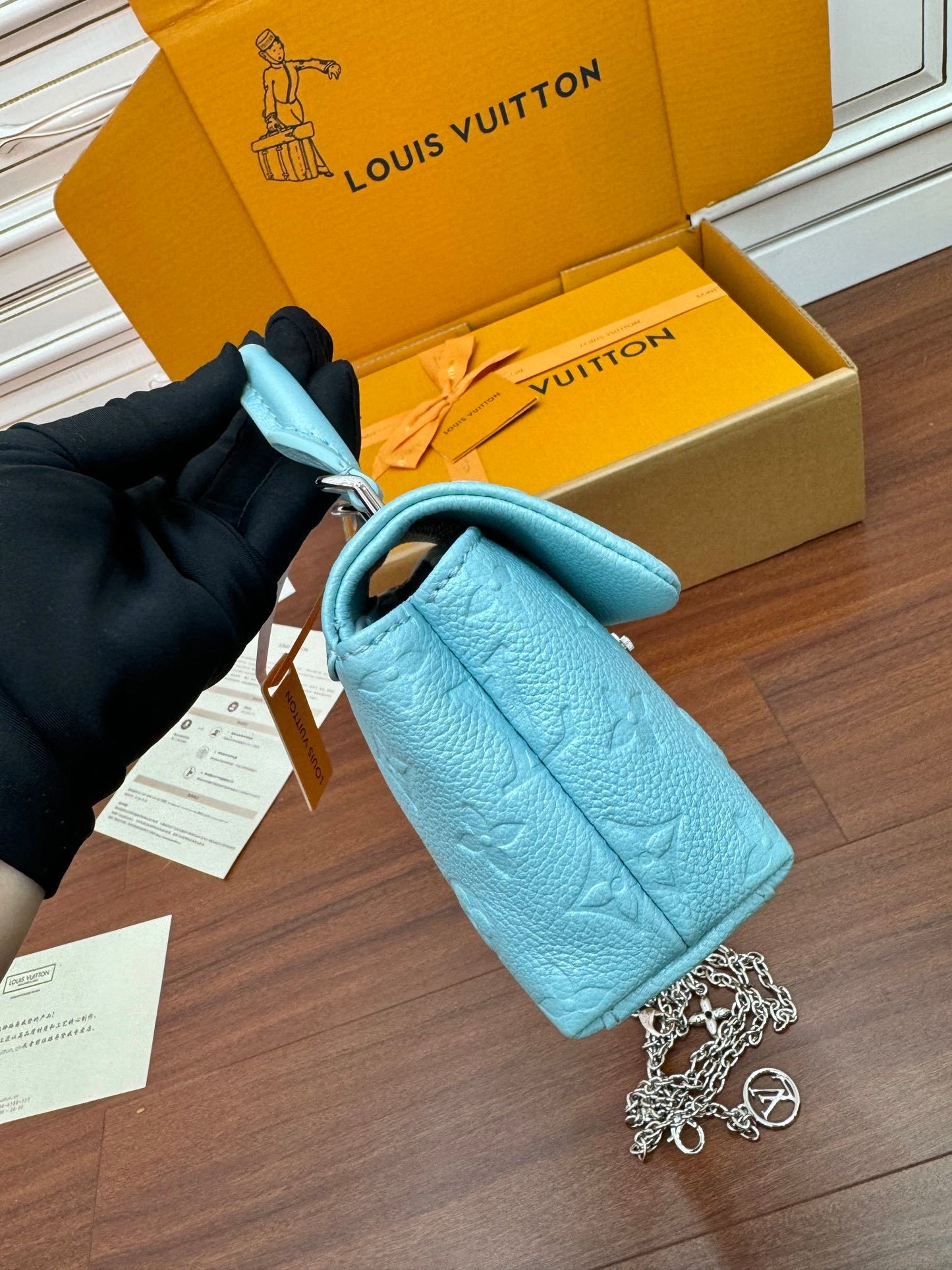 Louis Vuitton Nano Madeleine bag in the Azur Frost color in Monogram Empreinte leather.