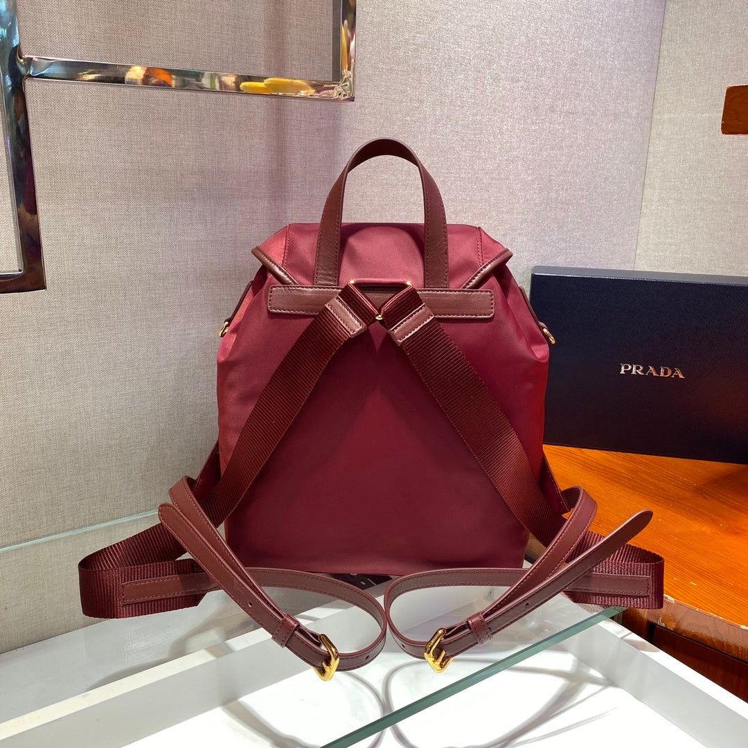 Prada Small Re-Nylon Backpack – Burgundy Red with Saffiano Leather Trim & Gold-Tone Hardware