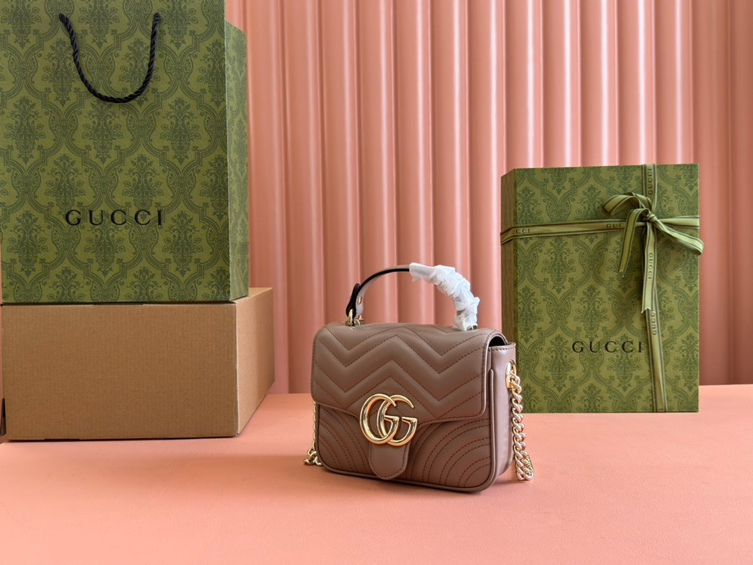 Gucci GG Marmont top handle bag in beige calfskin leather.