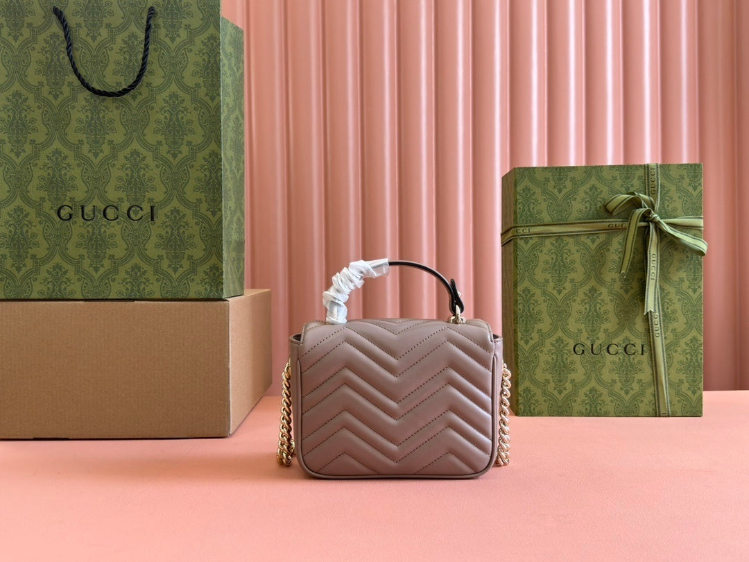 Gucci GG Marmont top handle bag in beige calfskin leather.