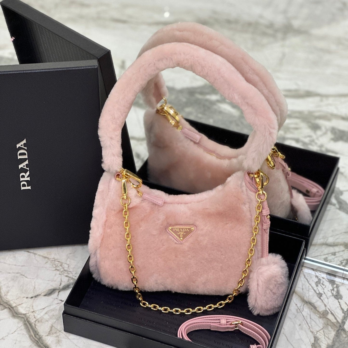 Prada Re-Edition Shearling Mini Bag – Pink with Gold-Tone Chain Strap & Enamel Logo