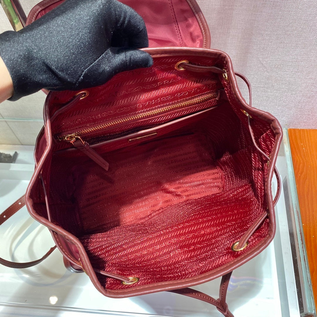 Prada Small Re-Nylon Backpack – Burgundy Red with Saffiano Leather Trim & Gold-Tone Hardware