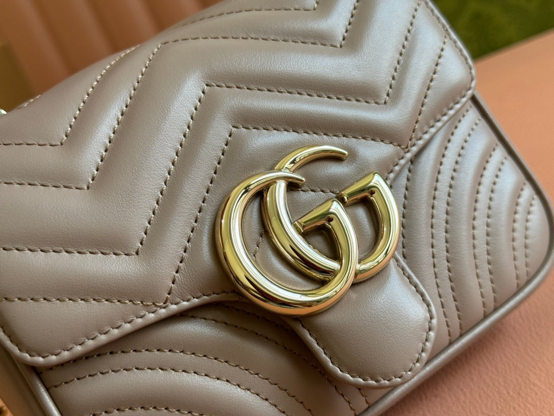 Gucci GG Marmont top handle bag in beige calfskin leather.