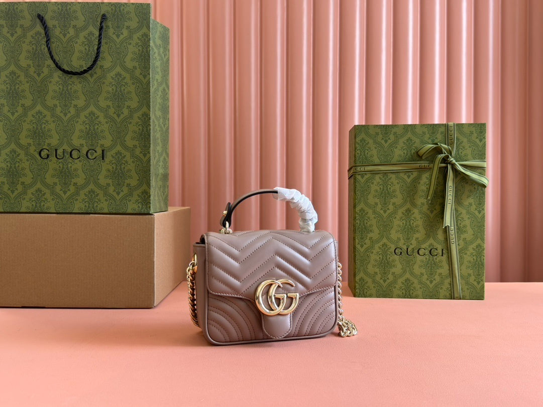 Gucci GG Marmont top handle bag in beige calfskin leather.