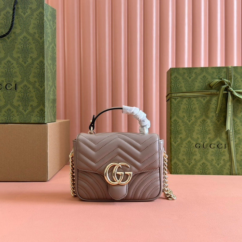 Gucci GG Marmont top handle bag in beige calfskin leather.