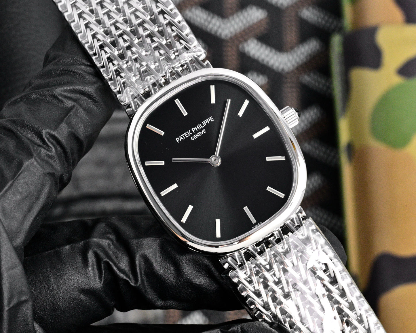 This Patek Philippe Golden Ellipse features a white gold case and a distinctive woven steel bracelet.
