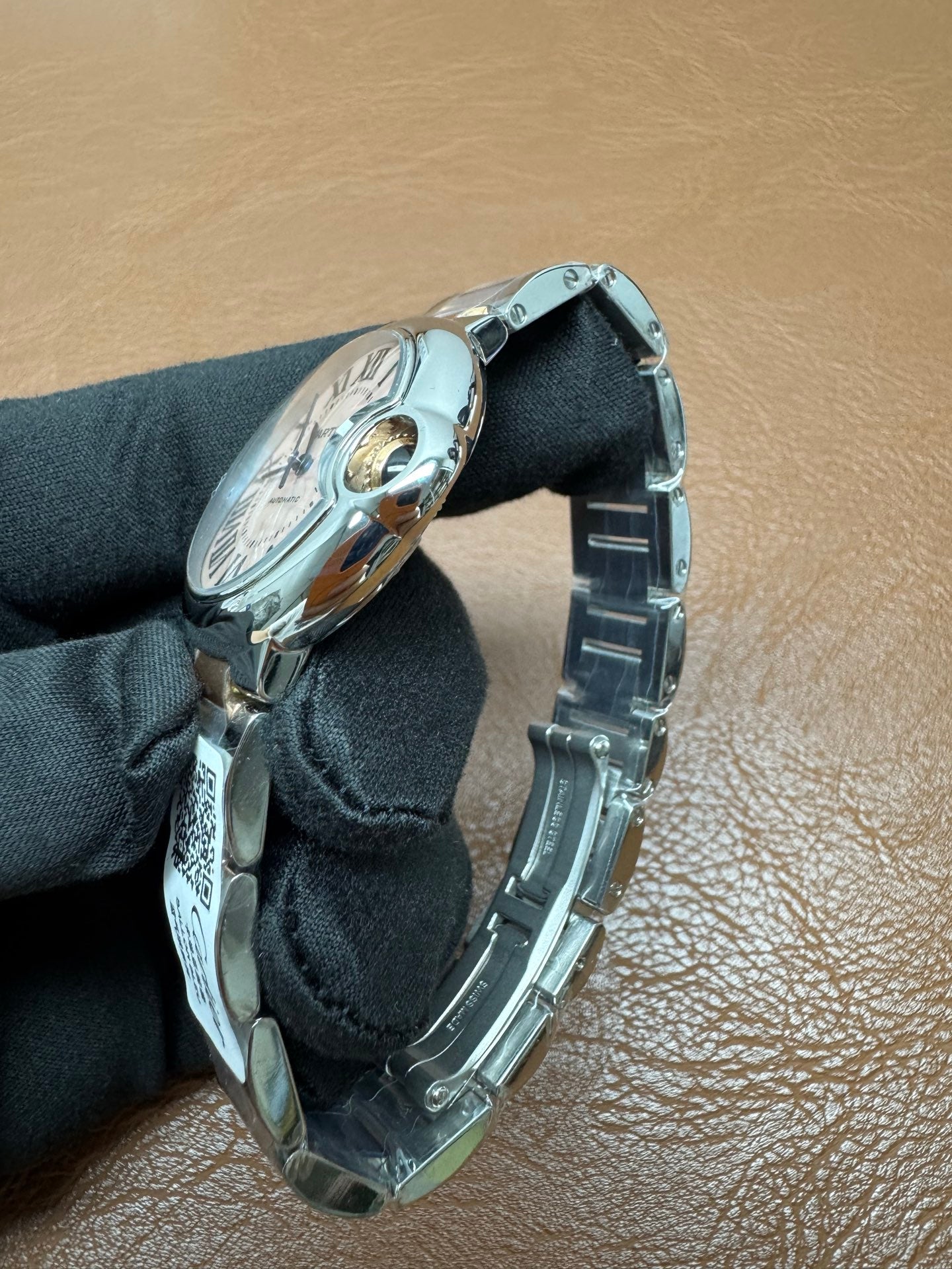 Cartier Ballon Bleu watch featuring a two-tone steel and gold bracelet and a distinctive pink dial